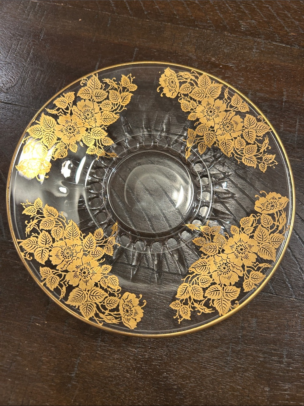 A vintage clear glass plate or bowl with a 22k gold floral overlay pattern